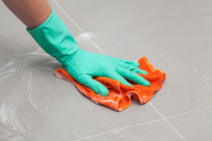 Image of hand cleaning floor