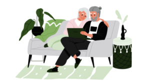 Older man and woman sitting on couch reviewing disaster plans on the computer.